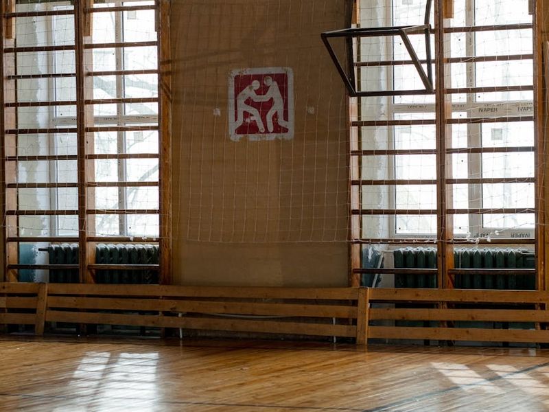 Minimalist training hall with natural sunlight and wooden floors